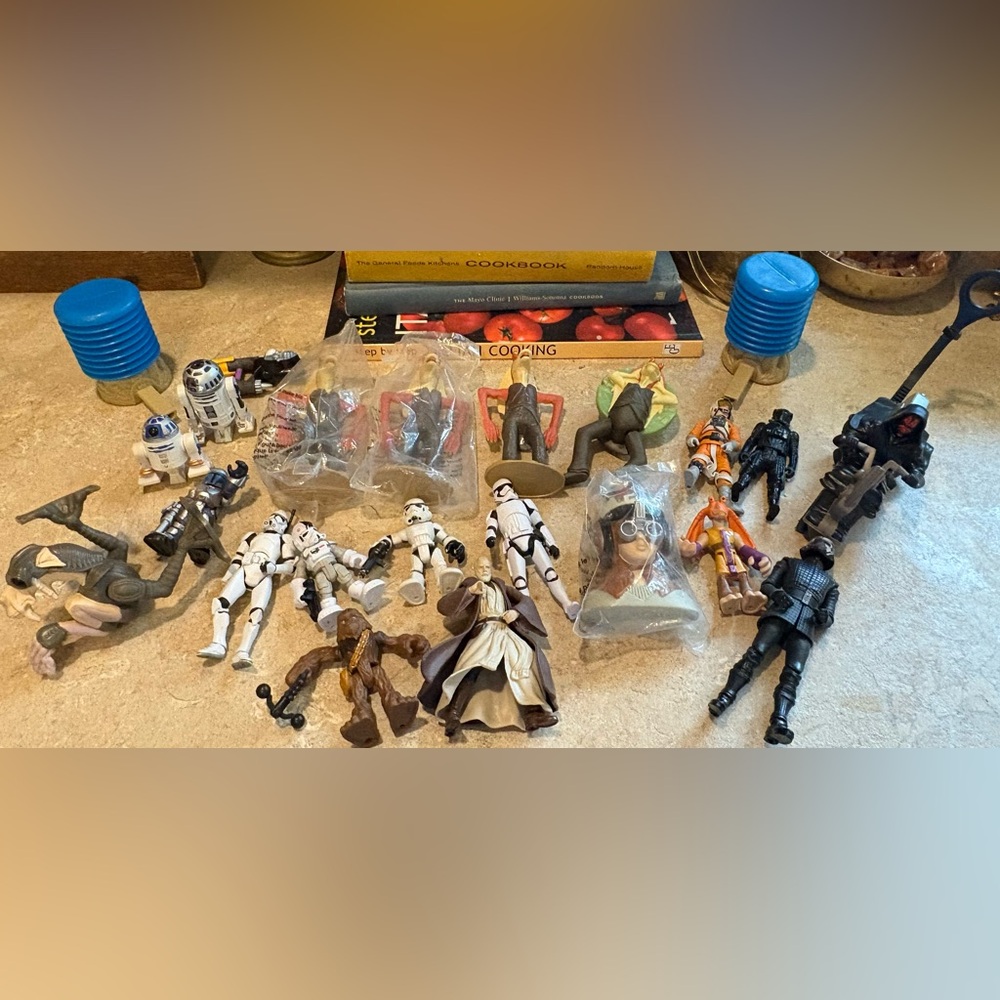 collection of various Star Wars action figures and other toys.